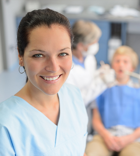 Friendly dental team member smiling in dental office