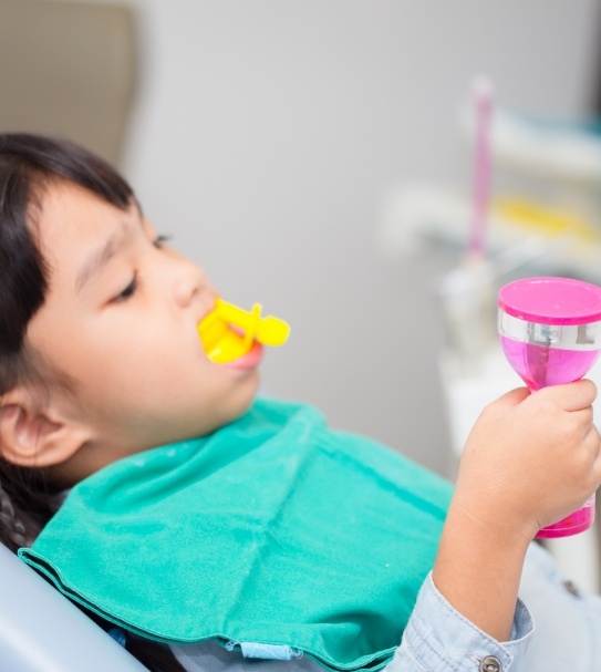 Child receiving silver diamine fluoride treatment