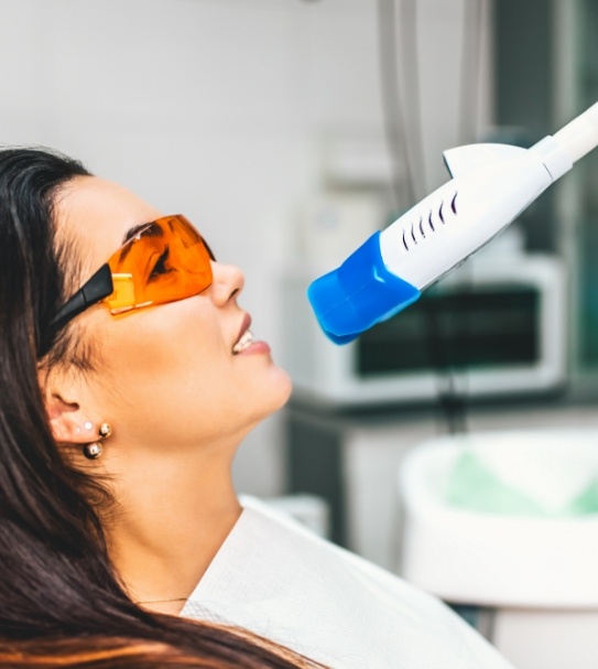 Woman receiving in office teeth whitening