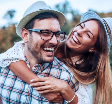 Man and woman with flawless smiles thanks to cosmetic dentistry