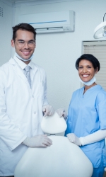 Dentist and dental team member in dental treatment room