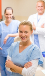 Three dental team members in dental treatment room