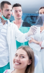 Dental team members and dental patient in treatment room