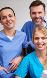 Three friendly dental team members