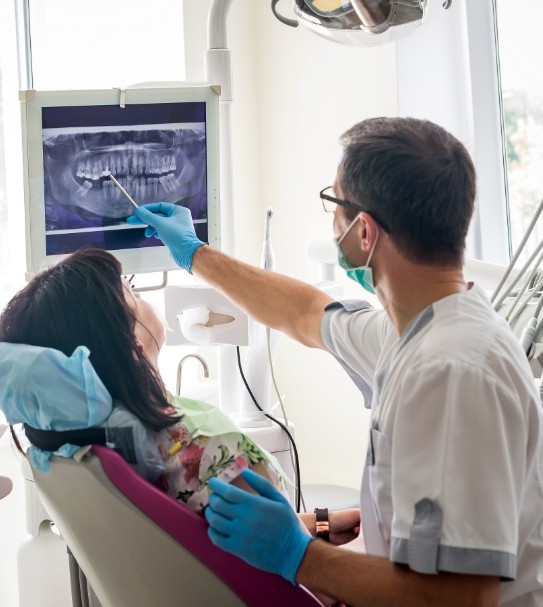 Dentist and dental patient looking at digital smile images