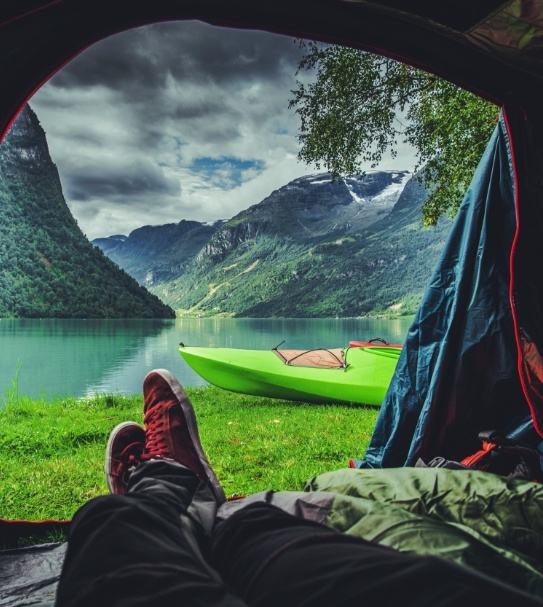 Person camping in beautiful mountain area