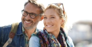 Man and woman with healthy smiles thanks to preventive dentistry