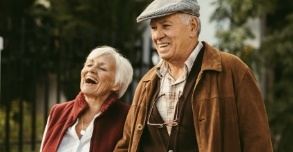 Older couple with full smiles thanks to tooth replacement options